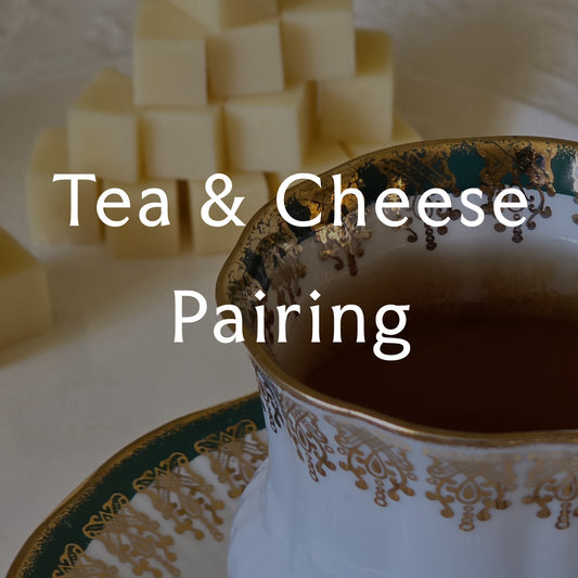 Tea cup with decorative patterns and cheese cubes on a white background overlaid with the text 'Tea & Cheese Pairing'
