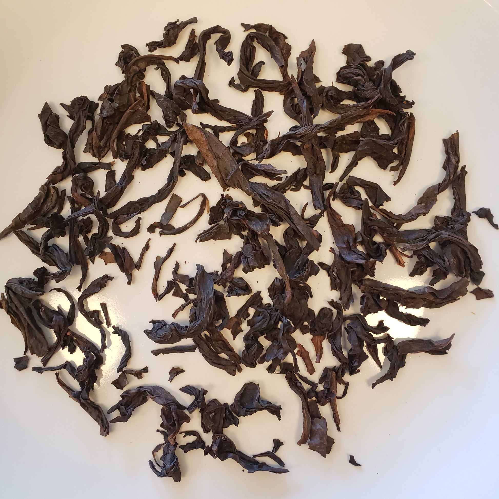 Dried tea leaves on a white background