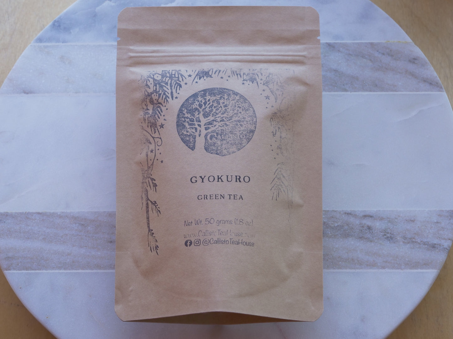 Kraft paper packaging of Gyokuro green tea on a marble surface