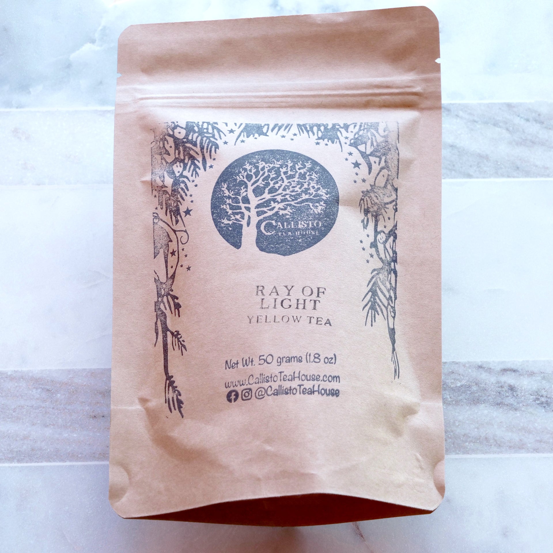 Tea package with Calisto Tea House branding on a light background