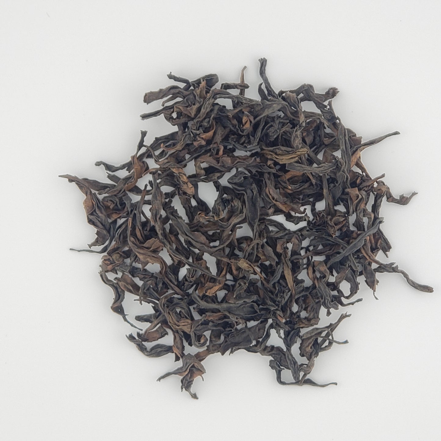 Close up of tea leaves on a white background
