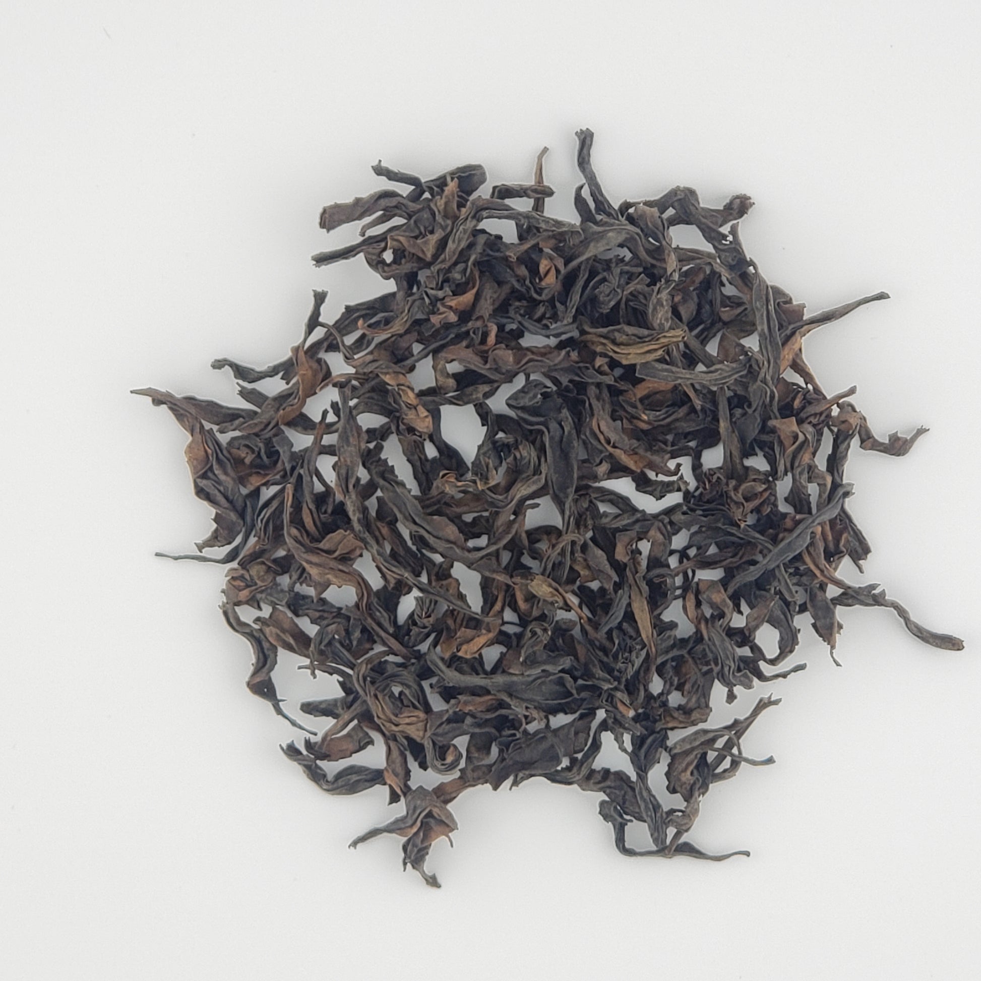 Close up of tea leaves on a white background