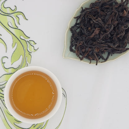 Tea leaves and a cup of brewed tea