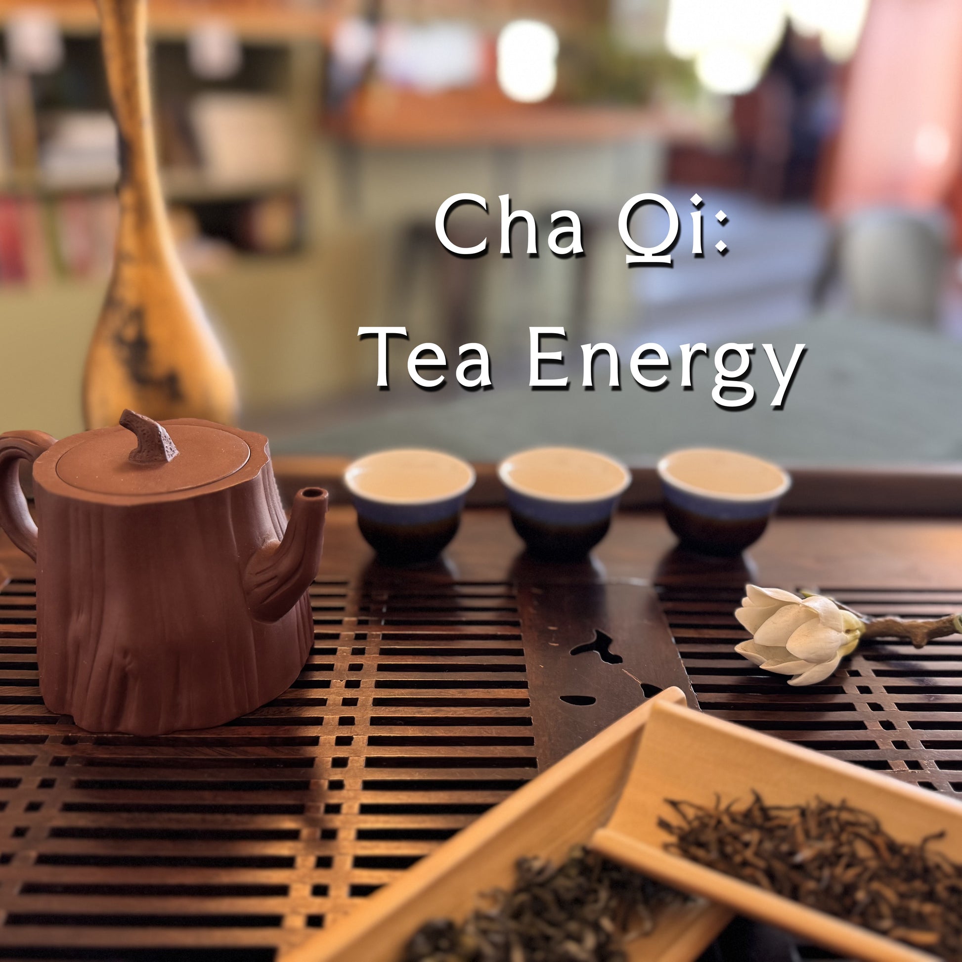 A wooden tea set arrangement on a slatted tray with a purple clay teapot, three small tea cups, loose leaf tea, and a white flower, overlaid with the text 'Cha Qi: Tea Energy'.
