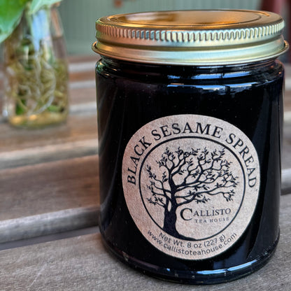 Jar of Black Sesame Spread with a visible label on a wooden surface
