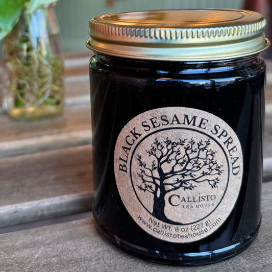 Jar of Black Sesame Spread with a visible label on a wooden surface