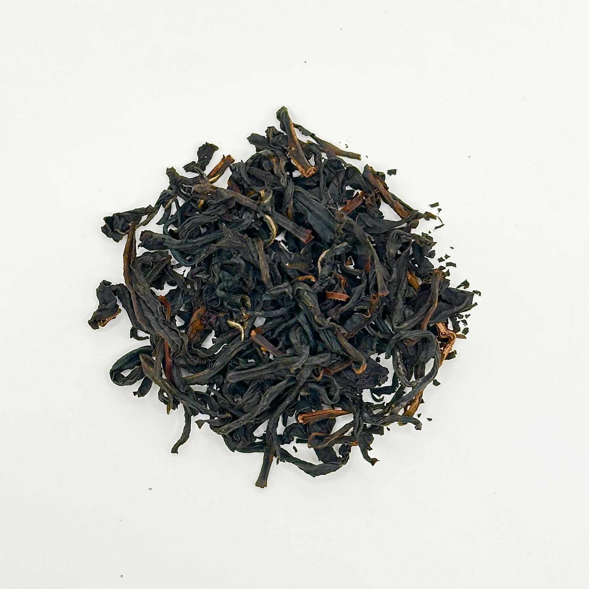 Black tea leaves on a white background