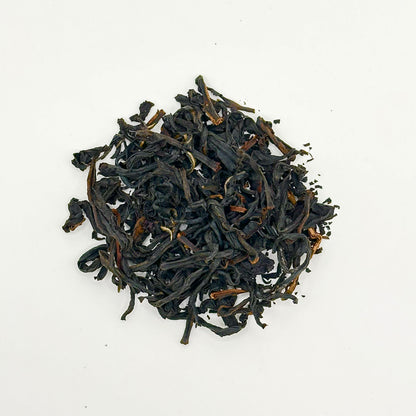 Black tea leaves on a white background