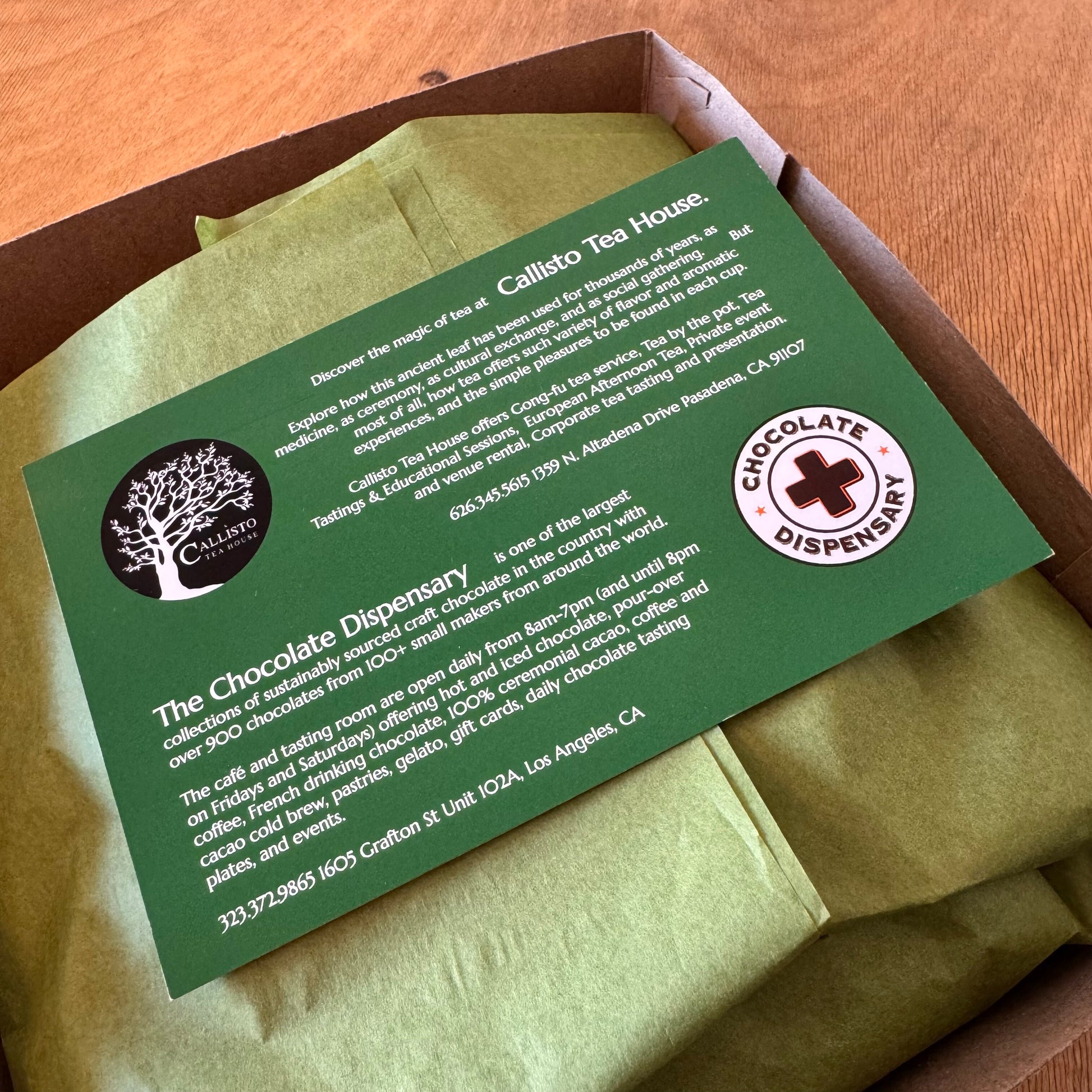 Green card with text and logos on a green paper package