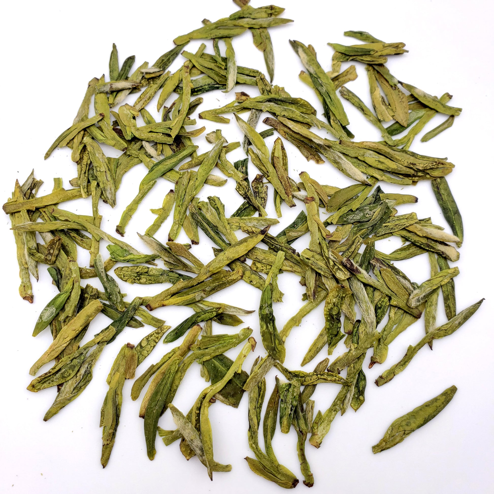 Green tea leaves on a white background