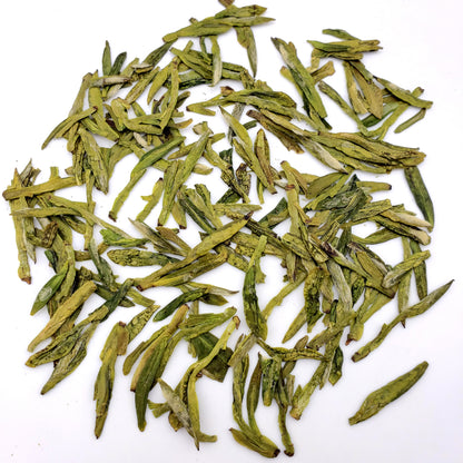Green tea leaves on a white background