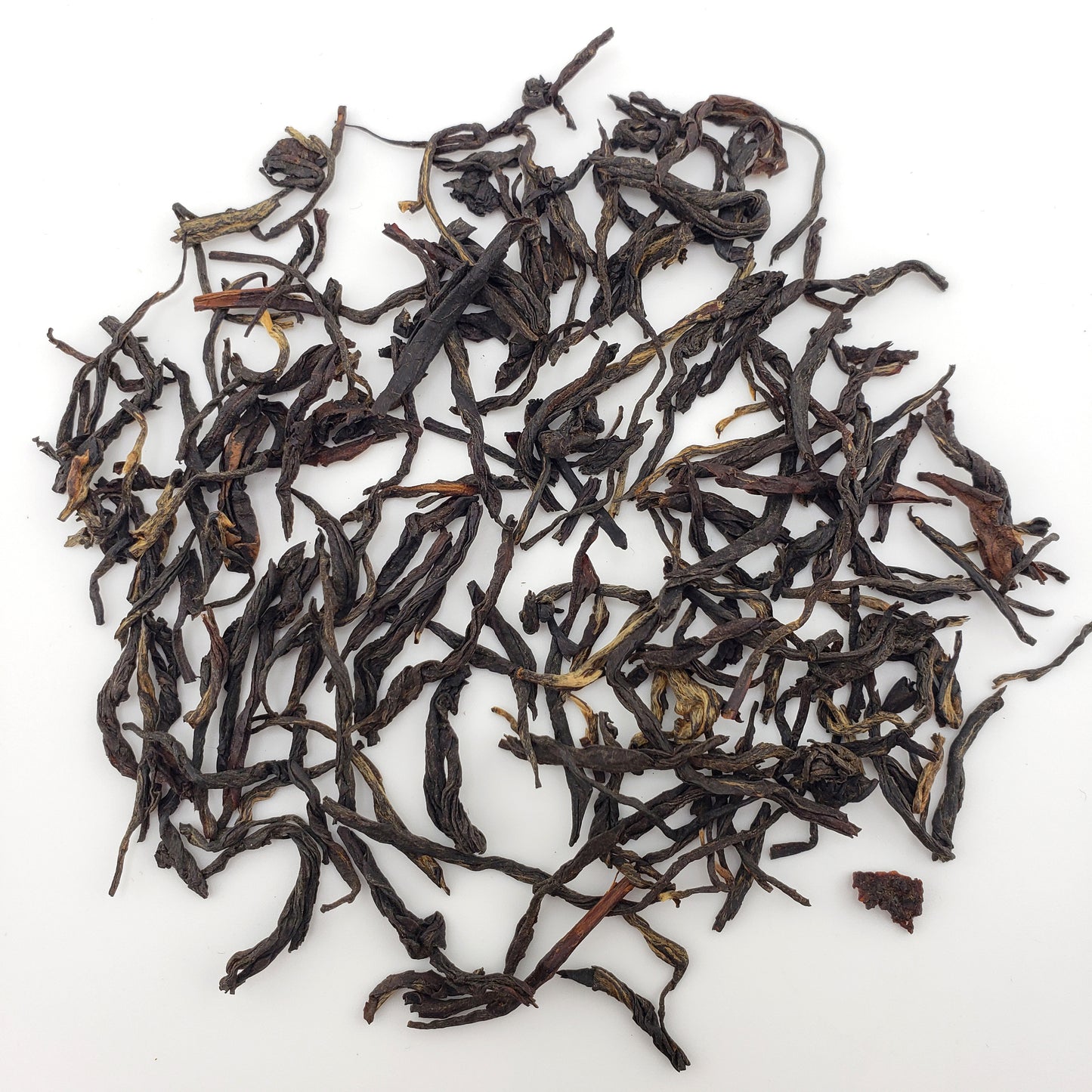 Dry black tea leaves on a white background