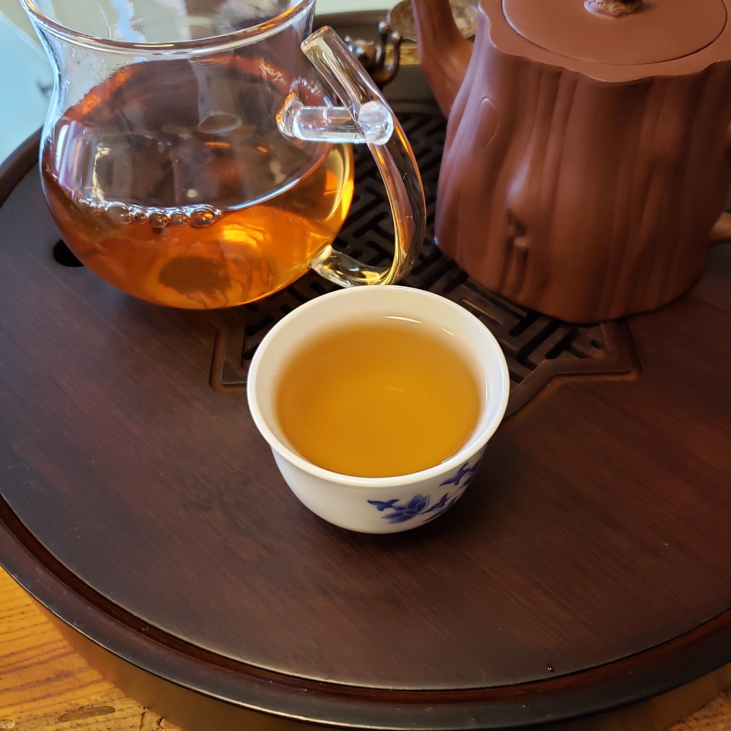 Tea pot and cup on a wooden table