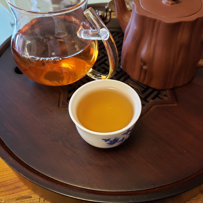 Tea pot and cup on a wooden table